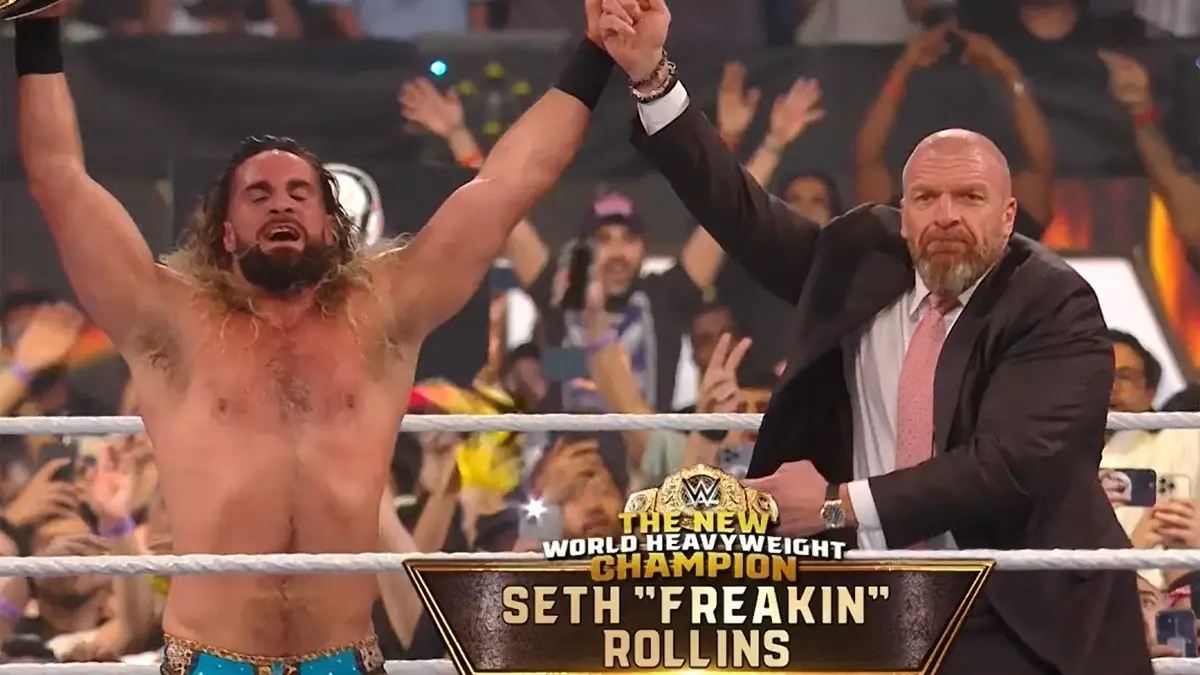Triple H and Seth Rollins celebrate his victory as the New WWE World Heavyweight Champion at Night of Champions 2023